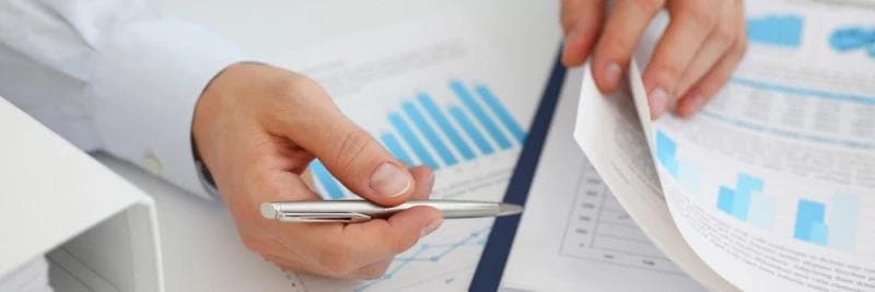 Male hands reviewing car accident statistics.